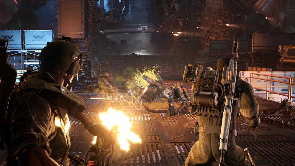 Two marines fire at Xenomorphs inside an industrial corridor in Aliens Fireteam Elite 2.