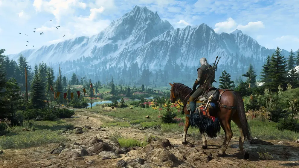 Geralt rides his horse Roach down a path toward a towering mountain in The Witcher 3's open world.