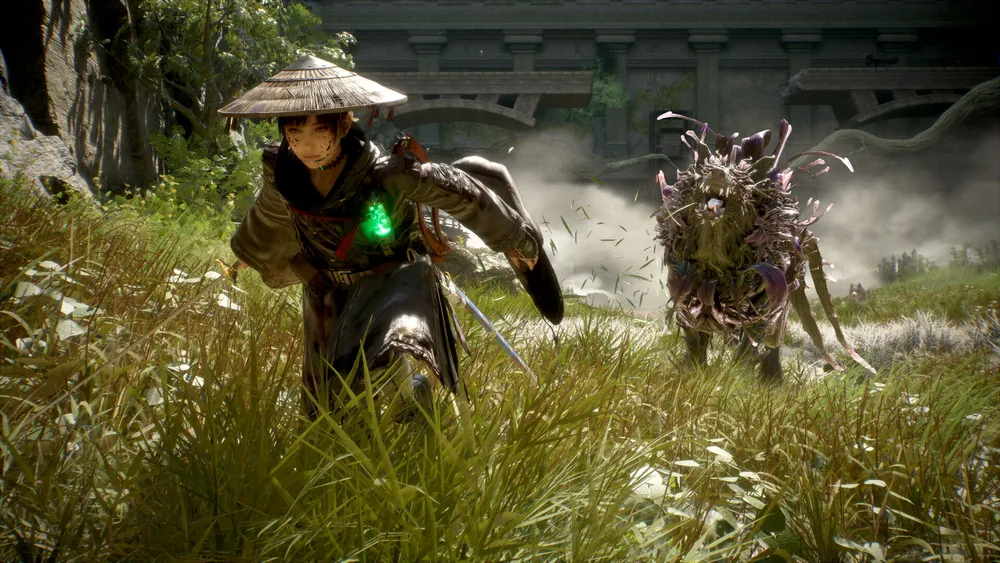 Emma runs through tall grass while a plant-covered creature follows close behind.