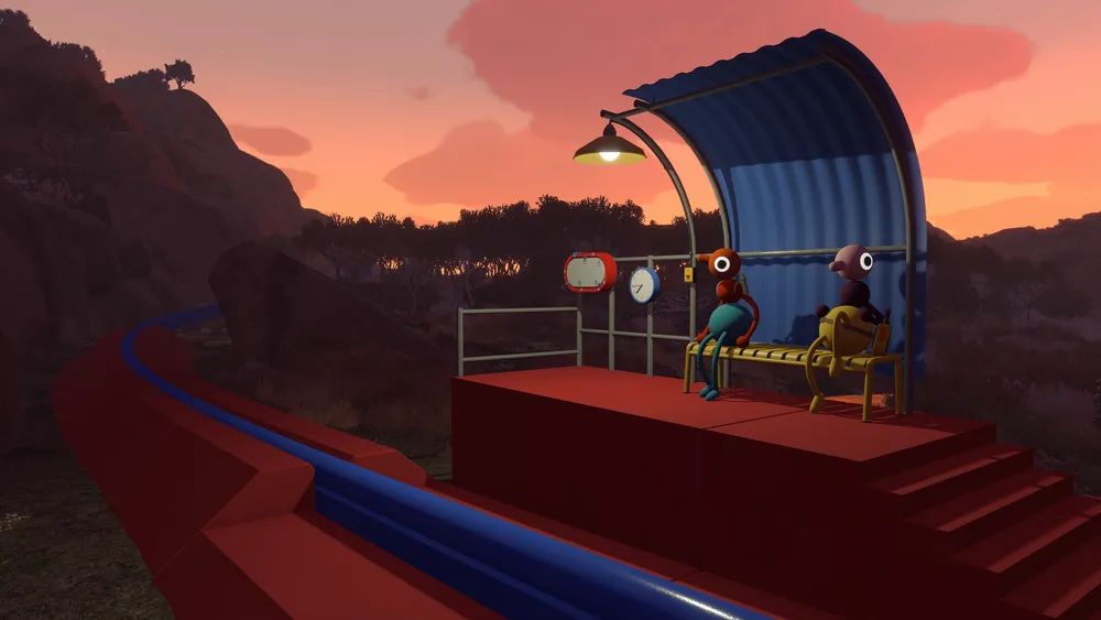Two colorful Big Walk characters sit together at a small shelter during sunset.