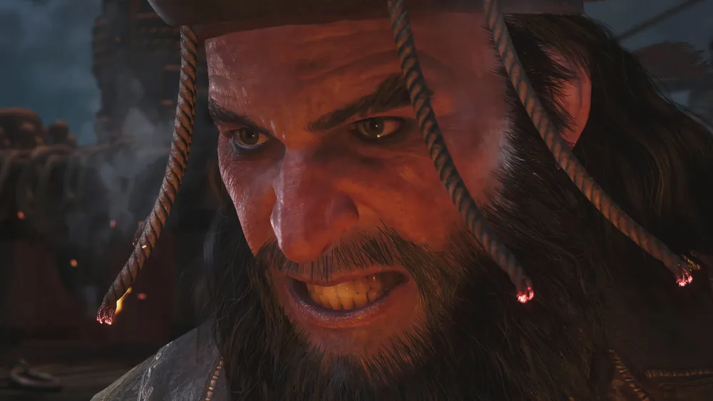 Close-up of Blackbeard snarling with lit fuses smoldering in his hat and beard in Assassin's Creed Black Flag Resynced