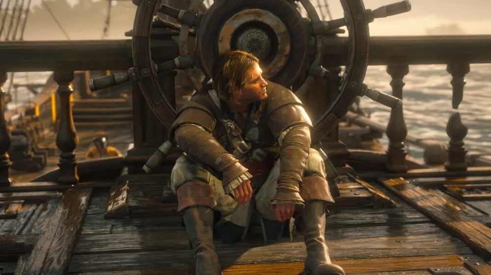 Edward Kenway sitting on the sunlit deck of the Jackdaw in front of the ship's wheel in Assassin's Creed Black Flag Resynced