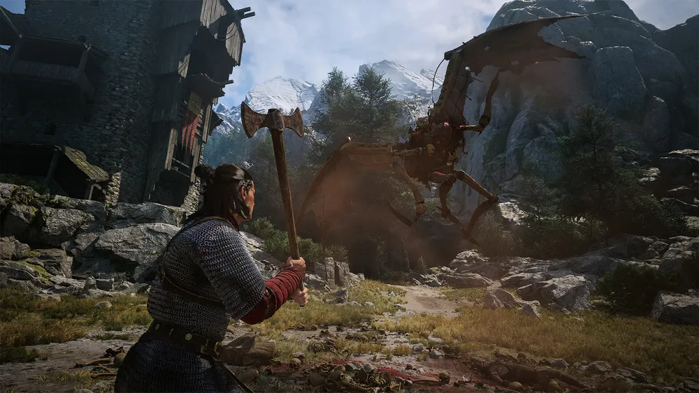 Coen raises an axe against a large winged creature landing among rocks outside a stone village, with snow-capped mountains behind them.