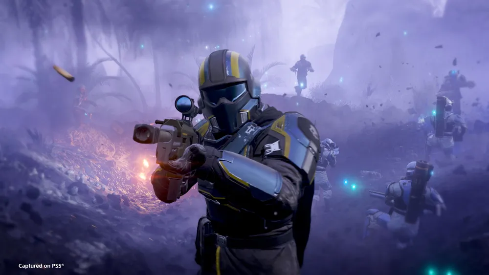 A Helldiver fires a weapon while towering machinery and enemy forces fill the background.