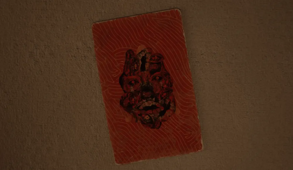 Key art for OD showing a worn red card on a textured wall, its face formed from many overlapping screaming faces.