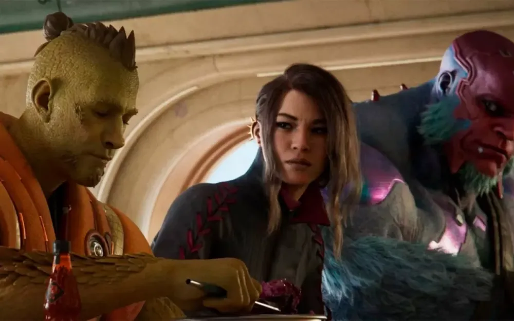 Three alien characters from the Concord trailer gathered around a table, one writing while the others look on.