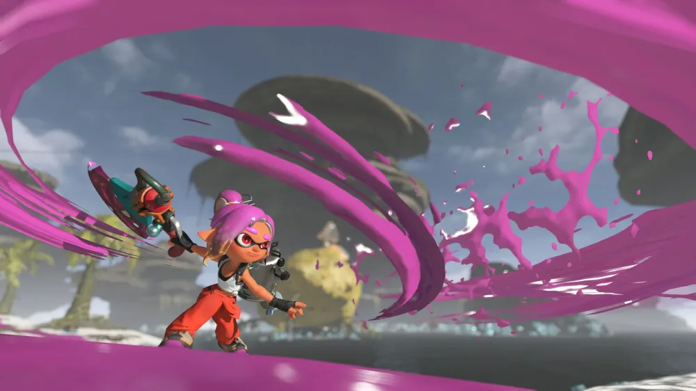 An Inkling in orange overalls swings a teal weapon as a wide arc of magenta ink sweeps across an island stage with floating rock formations.