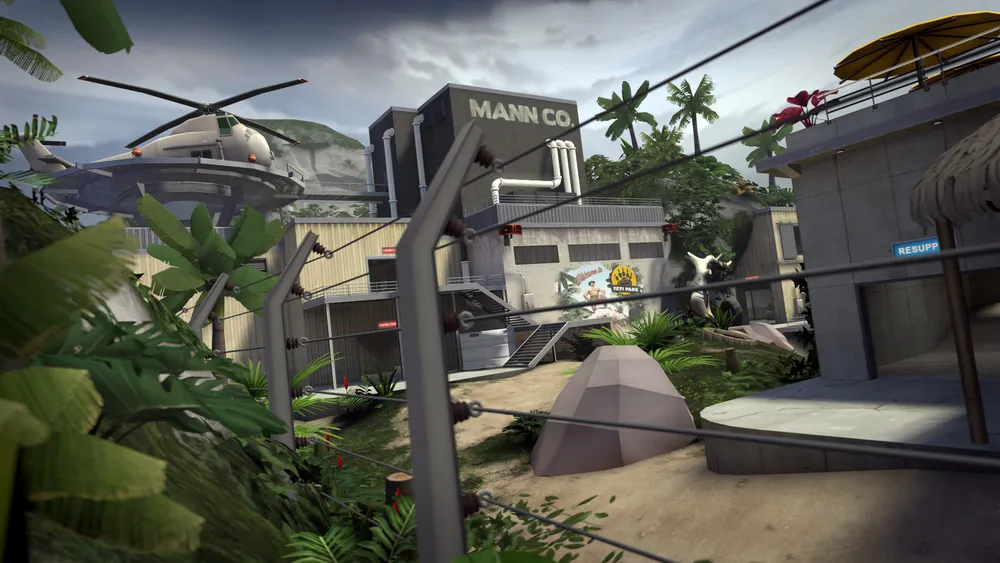 A Mann Co. facility, helicopter pad, and branching paths on Team Fortress 2's tropical Mercenary Park map.
