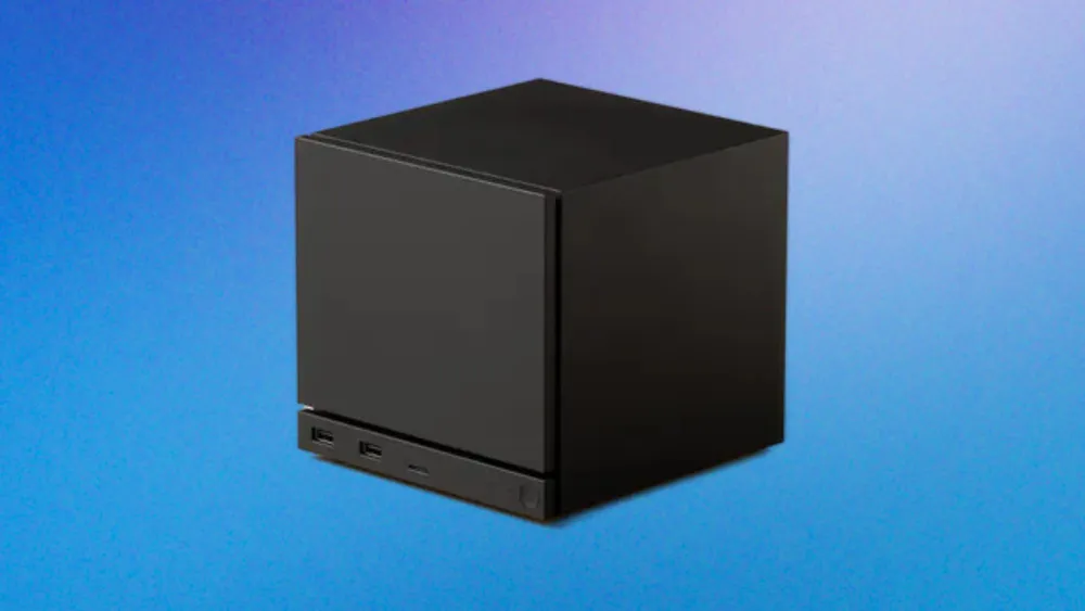 Valve's compact black Steam Machine photographed against a blue studio backdrop.